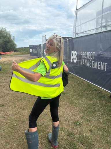 Lady in hi-vis jacket with back to the camera